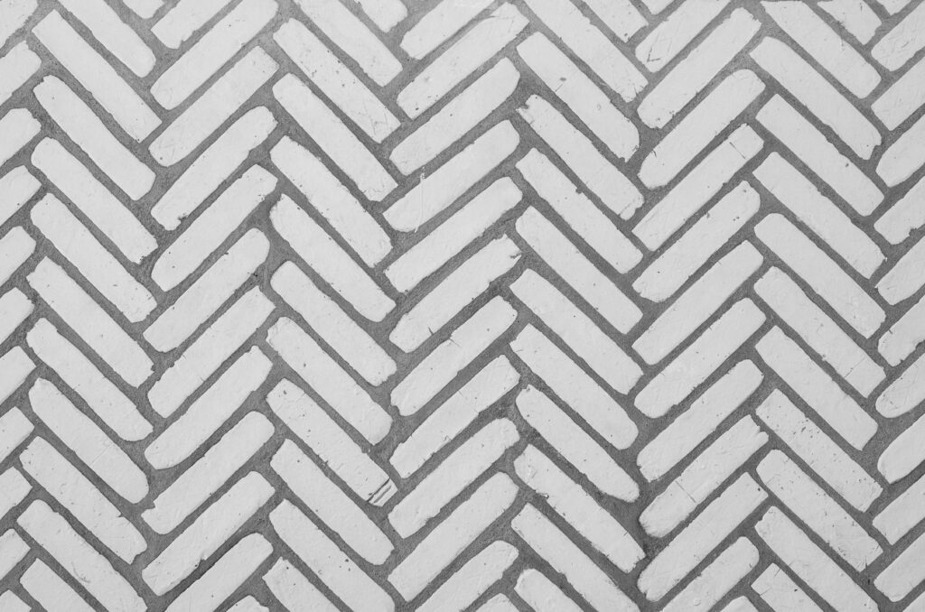 A close-up of a herringbone tile pattern in a kitchen space.