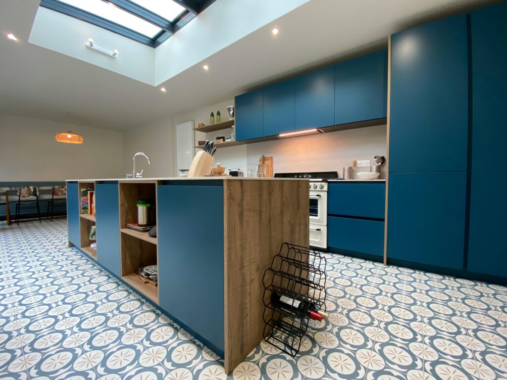 Herringbone pattern tile layout in a modern kitchen floor."