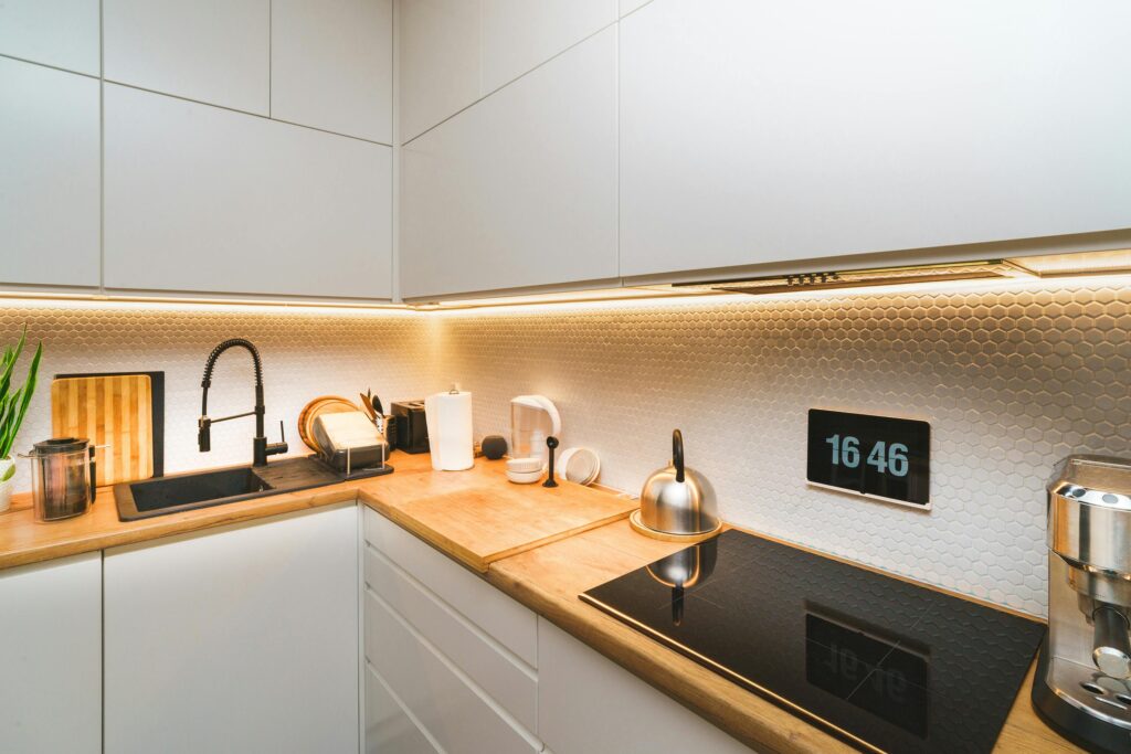 Kitchen with modern light fixtures and a sleek kitchen faucet.