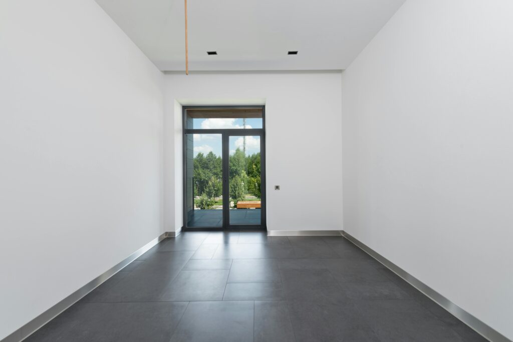 A spacious room with large format tiles that create a seamless, modern look.