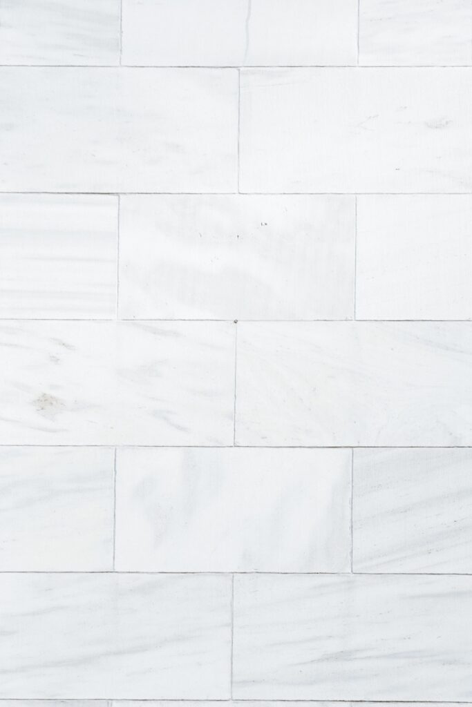 Stone flooring options, including marble, granite, and travertine, in a well-lit showroom, Dal Tile Showroom.