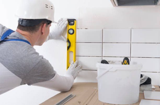 A professional installer measuring the area for labour cost to install peel and stick tile installation.