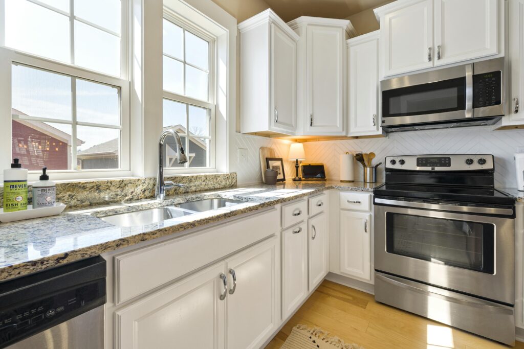 A clean and well-maintained peel and stick backsplash in a sunny kitchen.