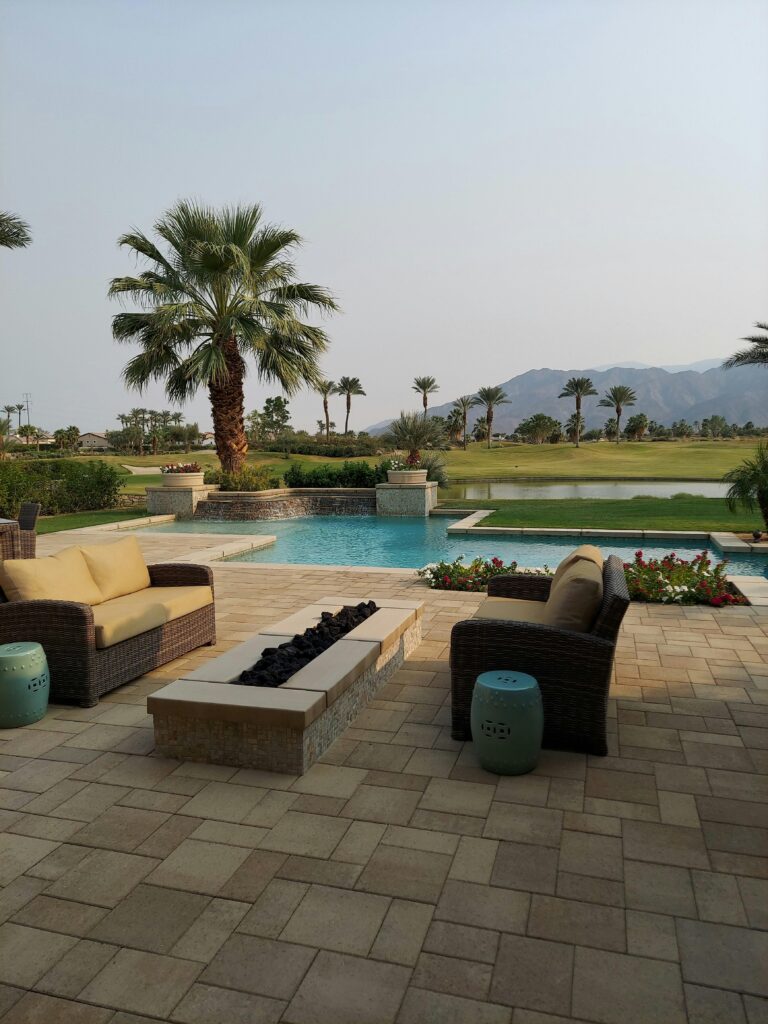 An outdoor patio with natural stone tiles and stylish furniture.