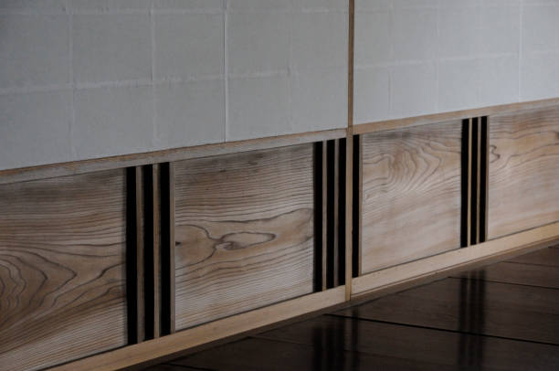 Pre-glued backsplash panels being installed over a large kitchen wall.