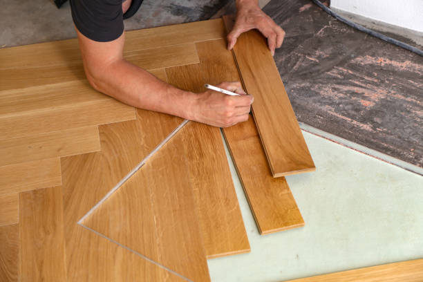 A homeowner clearing furniture from the floor before installation.