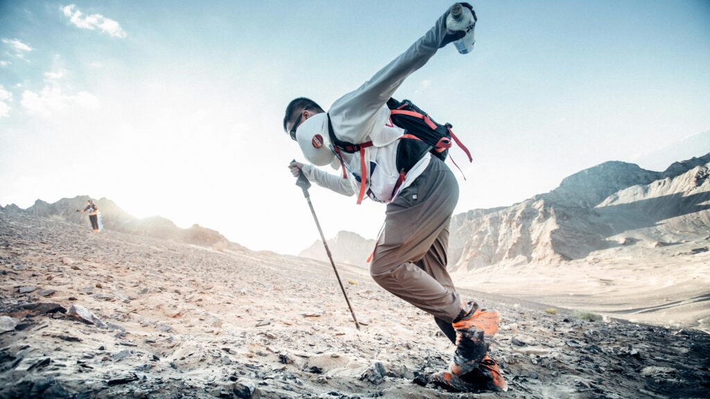 A person hiking uphill, symbolizing determination and resilience against challenges