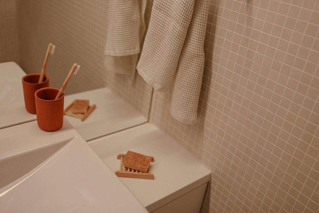 A tidy bathroom countertop with neatly arranged hygiene products like soap, toothbrushes, and towels,Health.